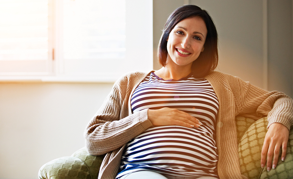 pregnant woman relaxing with hand on her tummy