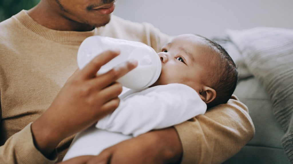 Dad bottle feeding his baby Dad bottle feeding his baby