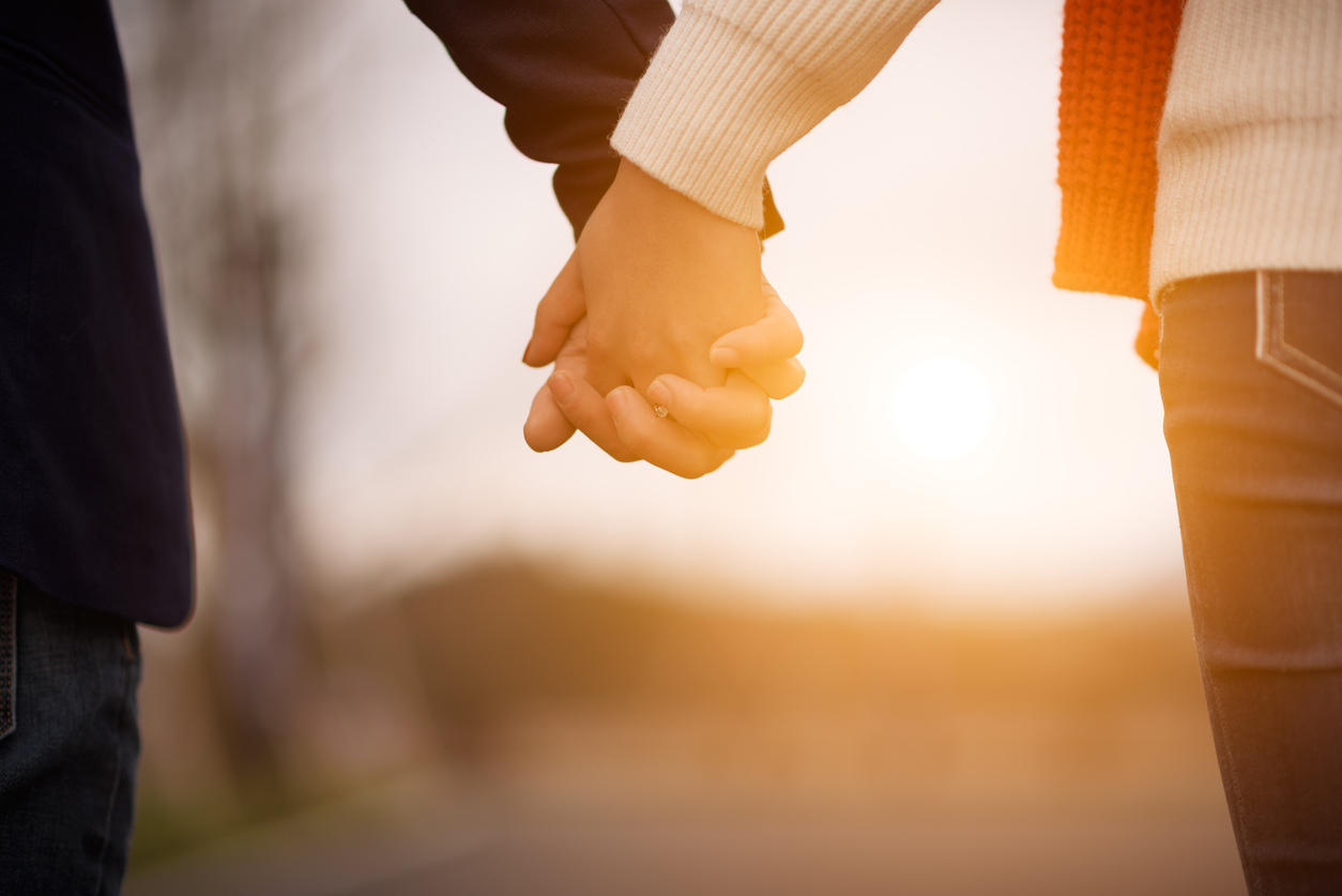 couple holding hands 